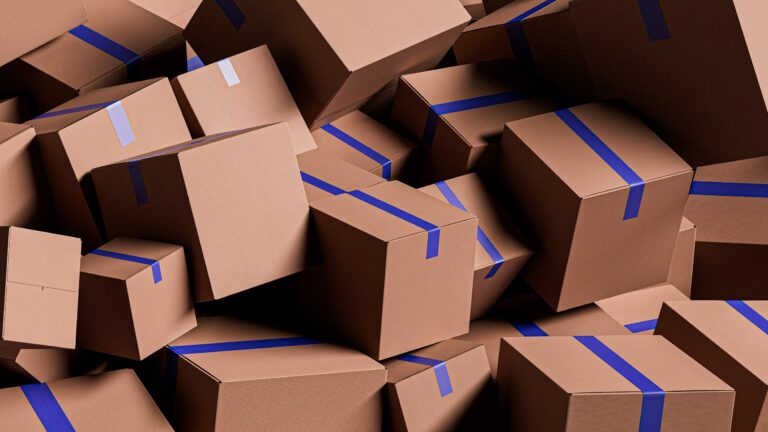 Pile of cardboard shipping boxes sealed with blue tape